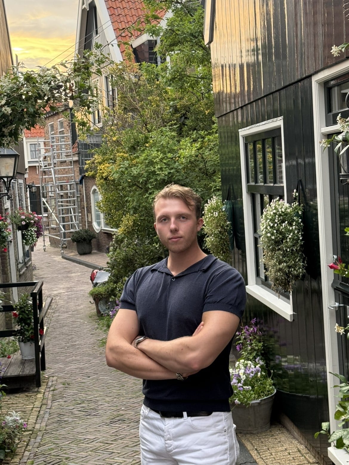 Lucas Kluft, standing in a narrow Dutch street at sunset